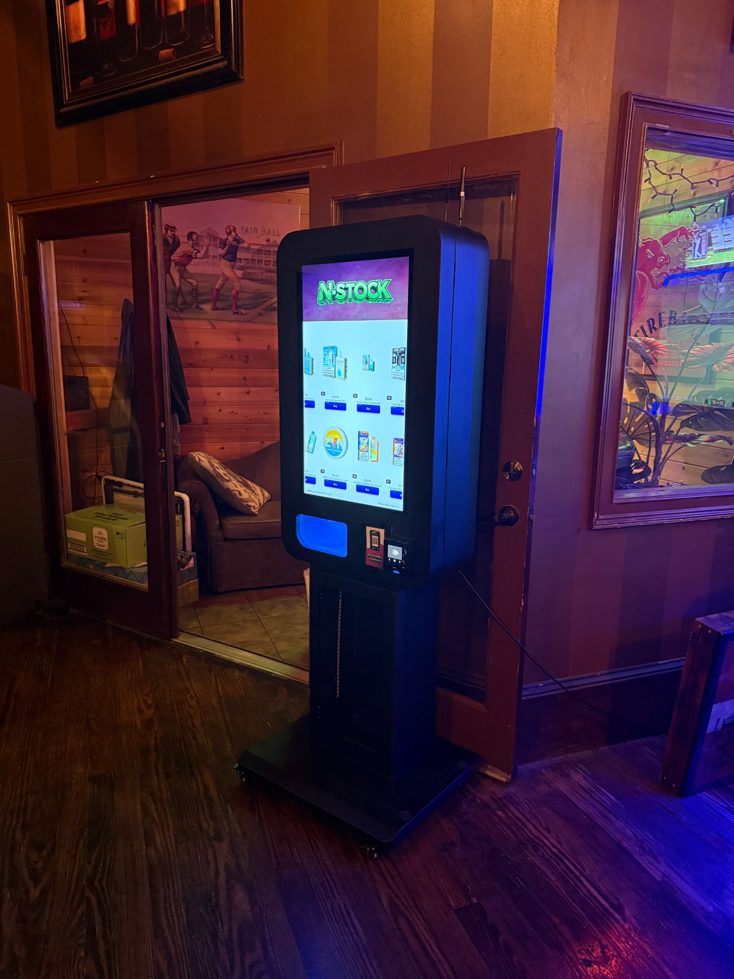 N-Stock vape machine with blue glow in a nightlife venue
